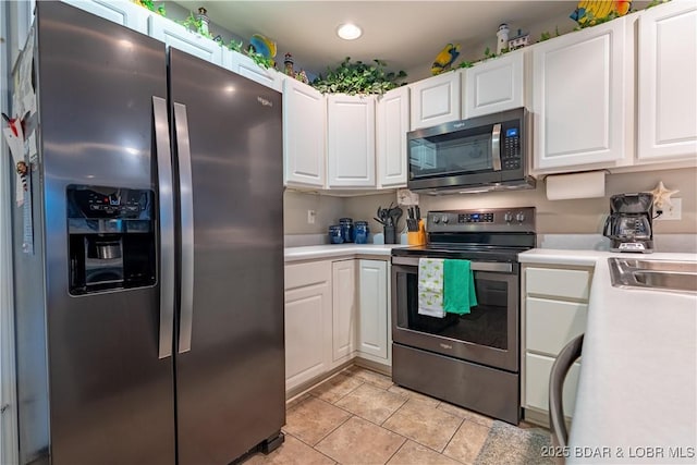 549 Park Place Dr Unit 2D, Kaiser, MO 65047 - kitchen with appliances with stainless steel finishes, light countertops, white cabinets, and recessed lighting