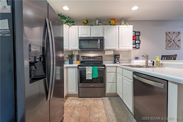 549 Park Place Dr Unit 2D, Kaiser, MO 65047 - kitchen with stainless steel appliances, a sink, white cabinets, light countertops, and recessed lighting