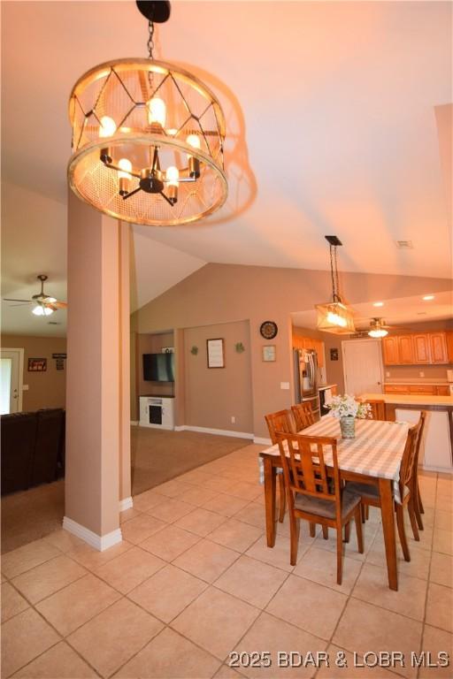 189 S Branch Ln, Eldon, MO 65026 - dining space featuring lofted ceiling, light tile patterned floors, baseboards, a chandelier, and a ceiling fan