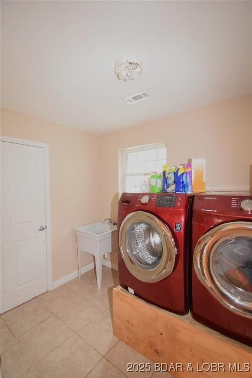 189 S Branch Ln, Eldon, MO 65026 - laundry room with washing machine and dryer, light tile patterned floors, and baseboards