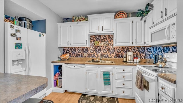 101 Circle Edge Unit 20-3A, Lake Ozark, MO 65049 - kitchen with white appliances, a sink, white cabinetry, light wood-style flooring, and backsplash