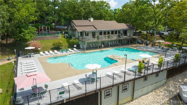 101 Circle Edge Unit 20-3A, Lake Ozark, MO 65049 - community pool featuring a patio area and view of wooded area
