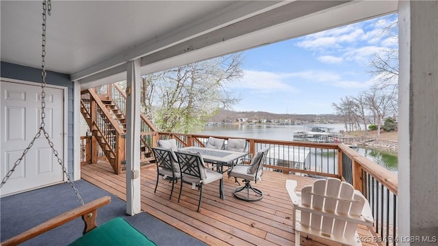 88 Hendrix Haven Dr, Sunrise Beach, MO 65079 - deck featuring a water view, stairs, and outdoor dining area
