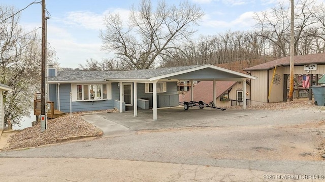 88 Hendrix Haven Dr, Sunrise Beach, MO 65079 - ranch-style house with a carport, a chimney, and driveway