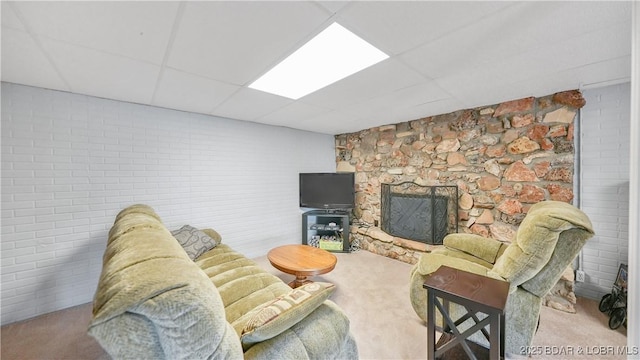 88 Hendrix Haven Dr, Sunrise Beach, MO 65079 - living room with a paneled ceiling, carpet floors, a fireplace, and brick wall