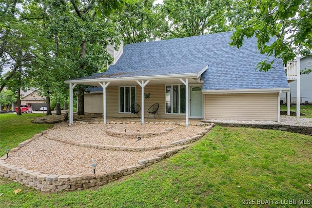 1556 Mockingbird Ln, Osage Beach, MO 65065 - back of house with a yard, a chimney, and a shingled roof