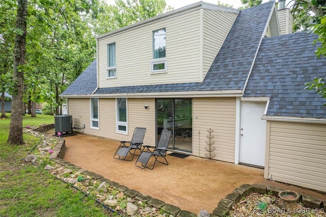 1556 Mockingbird Ln, Osage Beach, MO 65065 - rear view of property featuring a shingled roof, central AC unit, a patio, and a chimney