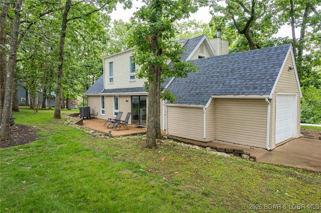 1556 Mockingbird Ln, Osage Beach, MO 65065 - back of house with a garage, roof with shingles, a lawn, and a chimney