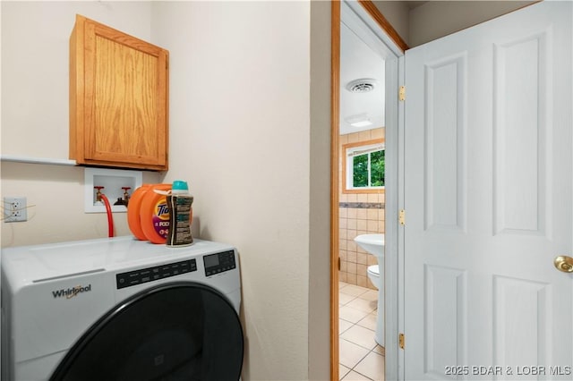 29825 Button Wood Ln, Rocky Mount, MO 65072 - laundry area with washer / dryer, light tile patterned floors, and cabinet space