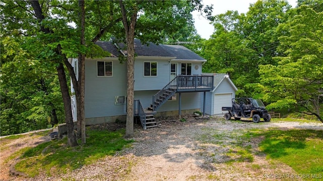 29825 Button Wood Ln, Rocky Mount, MO 65072 - rear view of property featuring stairway, driveway, a garage, and a deck