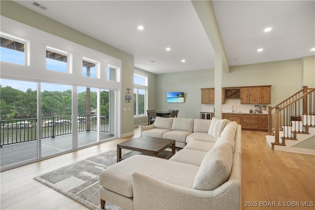 152 Pearl Ln, Climax Springs, MO 65324 - living room with light wood-type flooring, recessed lighting, stairway, and baseboards