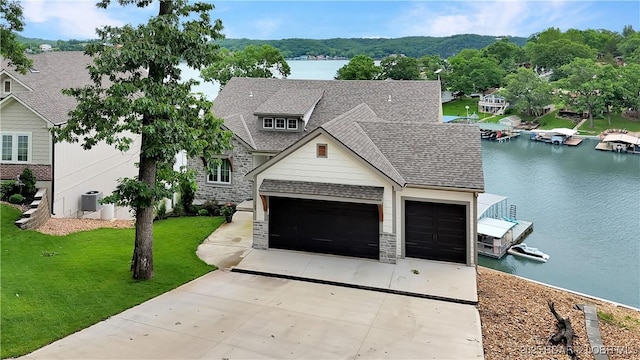 152 Pearl Ln, Climax Springs, MO 65324 - view of front facade featuring concrete driveway, stone siding, and a water view