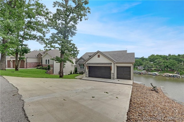 152 Pearl Ln, Climax Springs, MO 65324 - view of front of home with driveway, an attached garage, a front lawn, and a water view