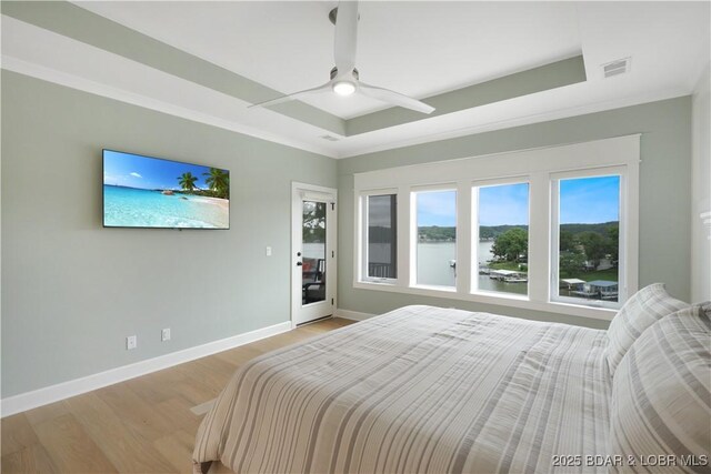 152 Pearl Ln, Climax Springs, MO 65324 - bedroom with a raised ceiling, light wood-style floors, baseboards, a ceiling fan, and access to exterior