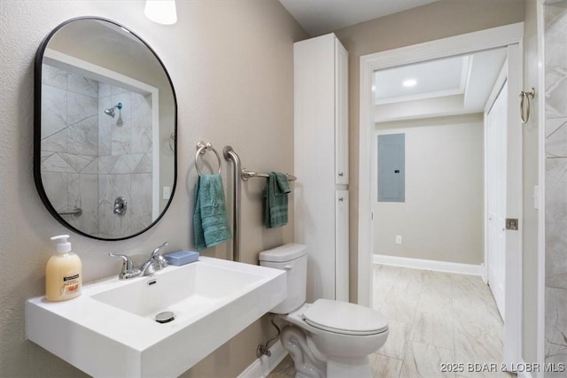 608 8th St, Eldon, MO 65026 - bathroom with electric panel, toilet, marble look tile flooring, a sink, and a raised ceiling