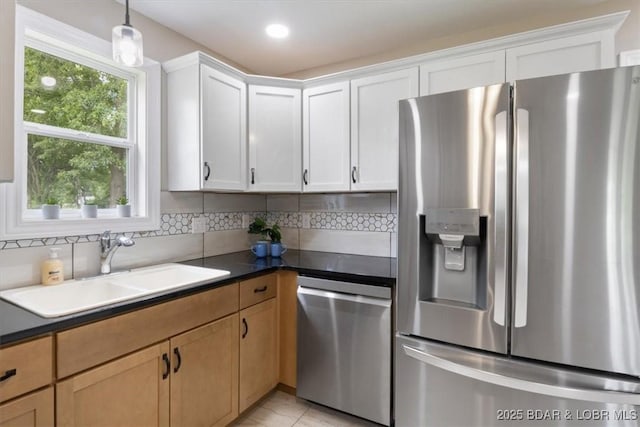 608 8th St, Eldon, MO 65026 - kitchen featuring appliances with stainless steel finishes, a sink, decorative backsplash, hanging light fixtures, and recessed lighting