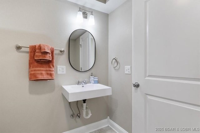 608 8th St, Eldon, MO 65026 - bathroom featuring baseboards and a sink