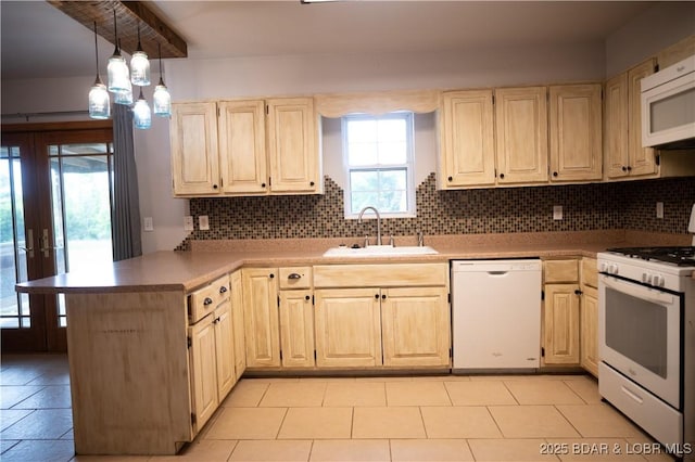 18 Chippewa Dr, Eldon, MO 65026 - kitchen featuring white appliances, a sink, a peninsula, backsplash, and hanging light fixtures