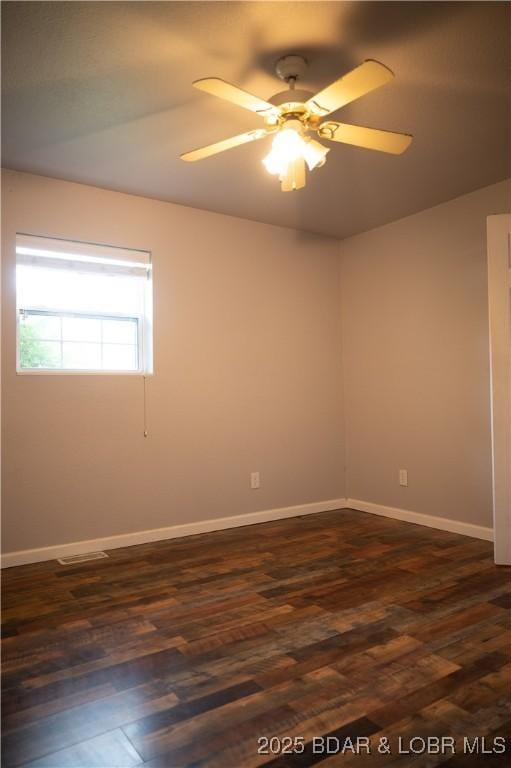 18 Chippewa Dr, Eldon, MO 65026 - empty room featuring dark wood-type flooring, a ceiling fan, and baseboards