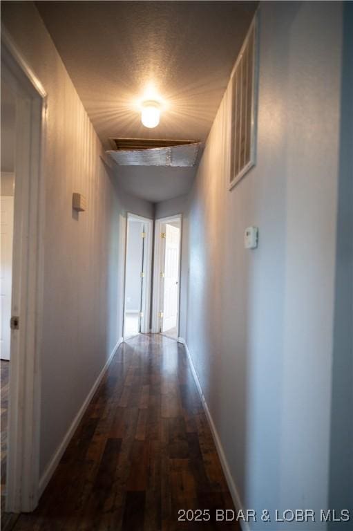 18 Chippewa Dr, Eldon, MO 65026 - hall featuring dark wood finished floors and baseboards