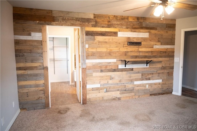 18 Chippewa Dr, Eldon, MO 65026 - empty room with wooden walls, a ceiling fan, carpet floors, and baseboards