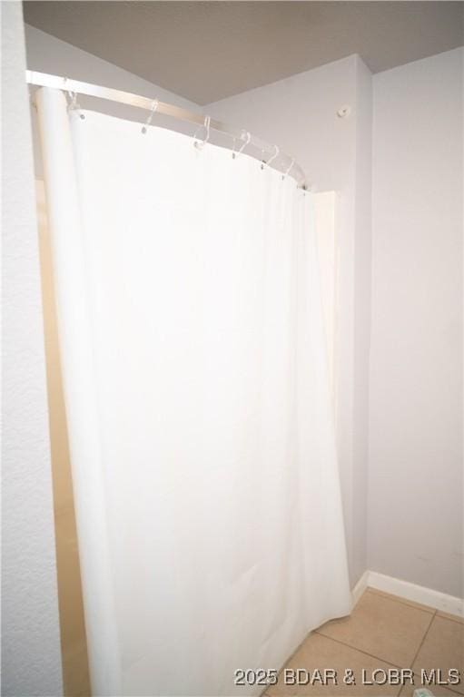 18 Chippewa Dr, Eldon, MO 65026 - bathroom featuring tile patterned floors, baseboards, and a shower with shower curtain