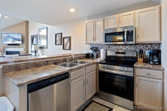 1481 Ledges Dr Unit 1047, Osage Beach, MO 65065 - kitchen featuring appliances with stainless steel finishes, a peninsula, light tile patterned floors, decorative backsplash, and open floor plan