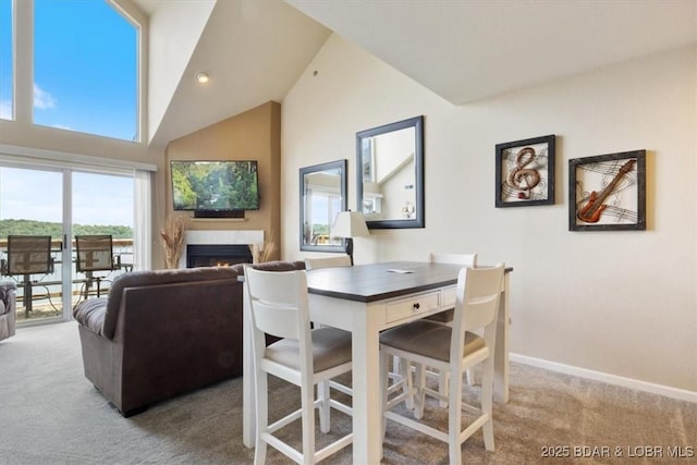 1481 Ledges Dr Unit 1047, Osage Beach, MO 65065 - carpeted dining room with a warm lit fireplace and lofted ceiling