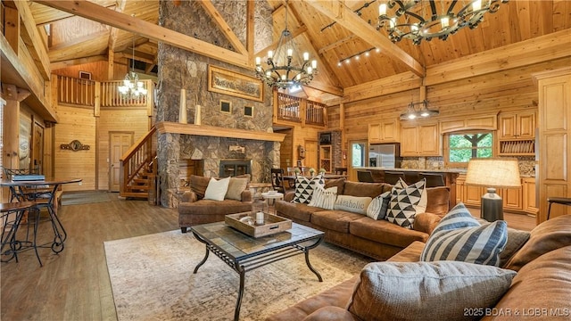 1624 Kays Point Rd, Four Seasons, MO 65049 - living room with a chandelier, wooden walls, high vaulted ceiling, stairway, and wood ceiling with exposed beams