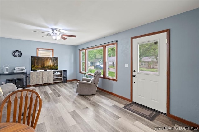 320 N Chestnut St, Eldon, MO 65026 - living area featuring light wood-type flooring, baseboards, and a ceiling fan