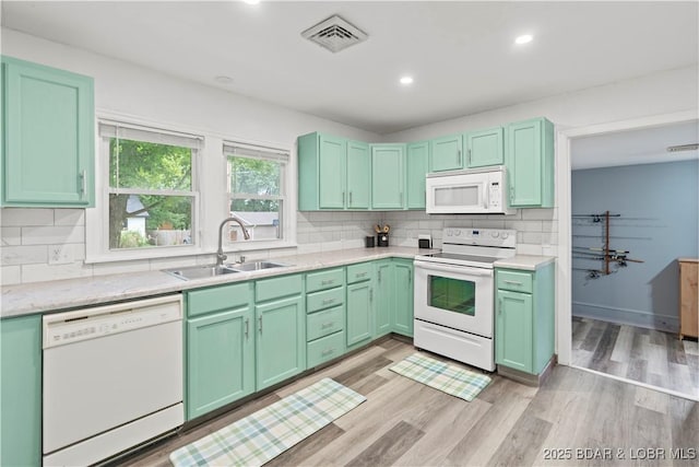 320 N Chestnut St, Eldon, MO 65026 - kitchen with white appliances, a sink, tasteful backsplash, light countertops, and recessed lighting