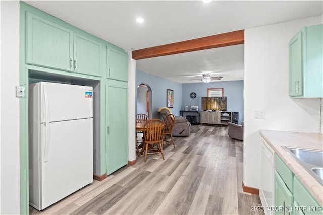320 N Chestnut St, Eldon, MO 65026 - kitchen with white appliances, light wood-style flooring, green cabinetry, light countertops, and beam ceiling