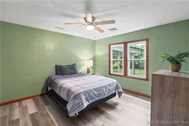 320 N Chestnut St, Eldon, MO 65026 - bedroom featuring baseboards, wood finished floors, and a ceiling fan