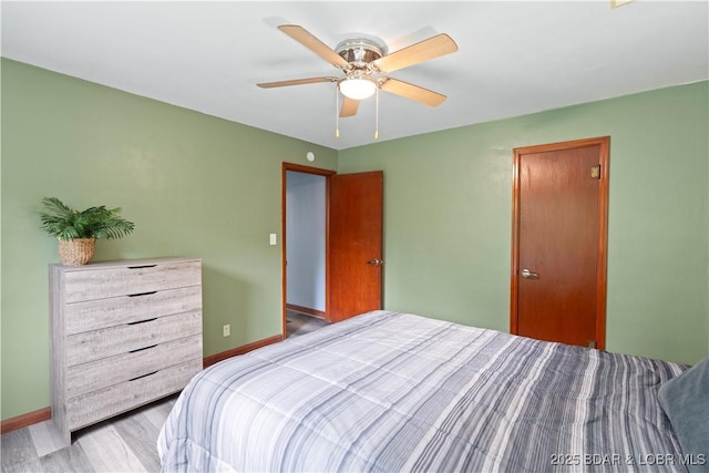 320 N Chestnut St, Eldon, MO 65026 - bedroom with baseboards, wood finished floors, and a ceiling fan