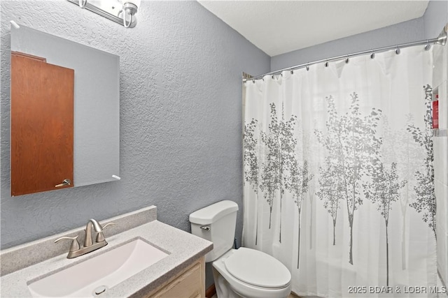 320 N Chestnut St, Eldon, MO 65026 - full bathroom featuring a textured wall, toilet, vanity, and a shower with shower curtain