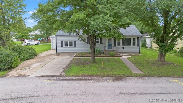 320 N Chestnut St, Eldon, MO 65026 - view of front of house featuring a front yard, driveway, and roof with shingles