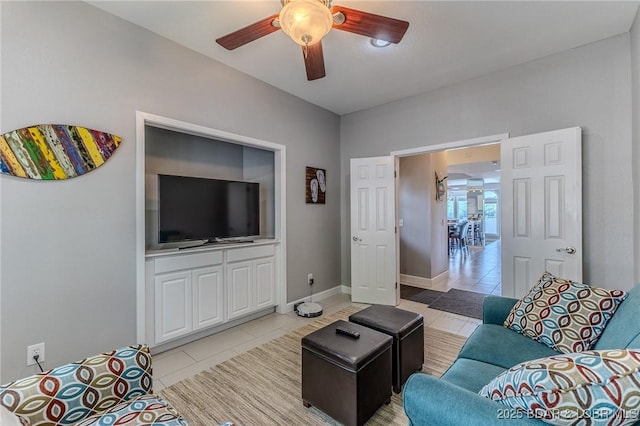 757 Malibu Rd Unit A102, Osage Beach, MO 65065 - living room with light tile patterned flooring, a ceiling fan, and baseboards