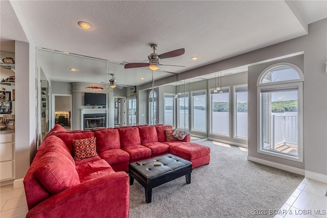 757 Malibu Rd Unit A102, Osage Beach, MO 65065 - living area with a ceiling fan, a textured ceiling, light colored carpet, recessed lighting, and a glass covered fireplace