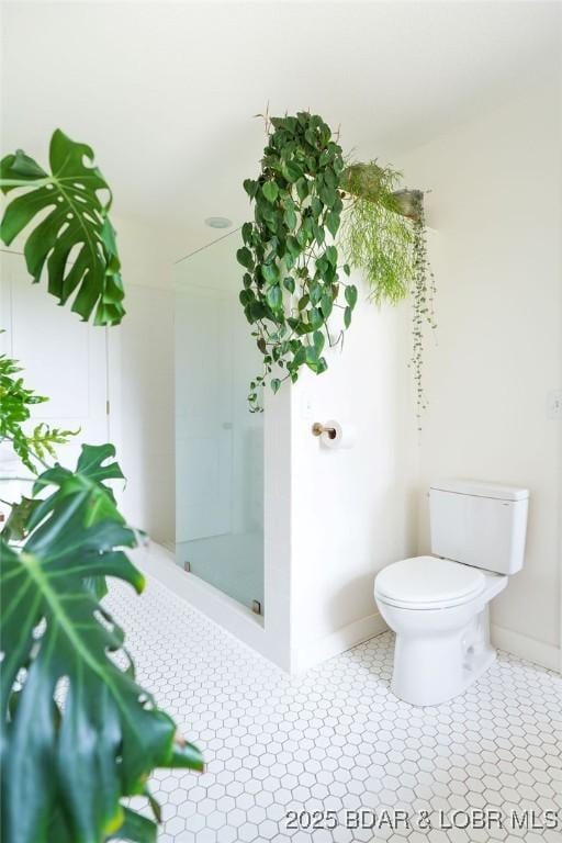 248 Midway Rd, Eldon, MO 65026 - bathroom with toilet, baseboards, and a shower stall