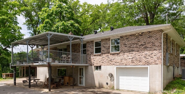 248 Midway Rd, Eldon, MO 65026 - rear view of house with a garage, brick siding, central AC unit, and a patio