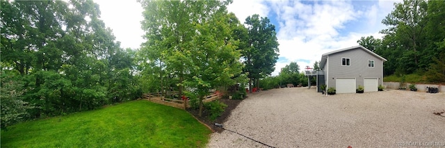 31762 Pecan Dr, Rocky Mount, MO 65072 - view of green lawn with gravel driveway, a garage, and a vegetable garden