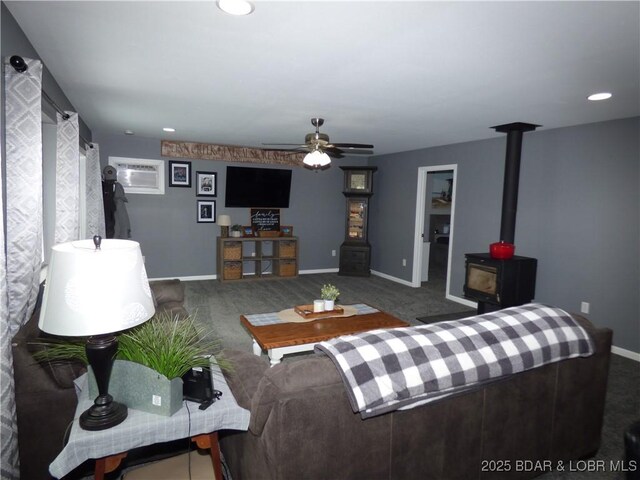 31762 Pecan Dr, Rocky Mount, MO 65072 - living room featuring carpet flooring, a wood stove, ceiling fan, recessed lighting, and a wall mounted AC