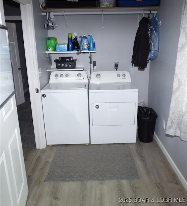 31762 Pecan Dr, Rocky Mount, MO 65072 - laundry room with washer and dryer and wood finished floors