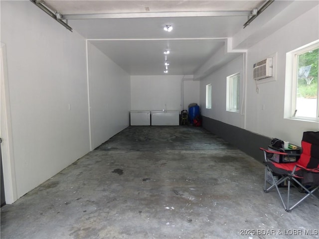 31762 Pecan Dr, Rocky Mount, MO 65072 - garage featuring a wall unit AC
