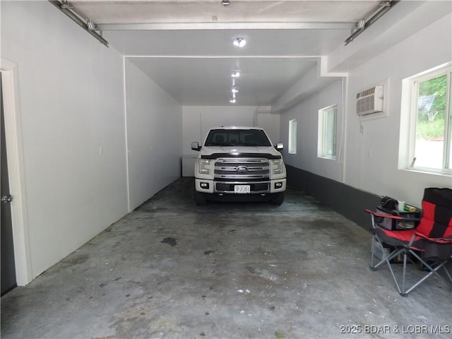 31762 Pecan Dr, Rocky Mount, MO 65072 - garage featuring a wall unit AC