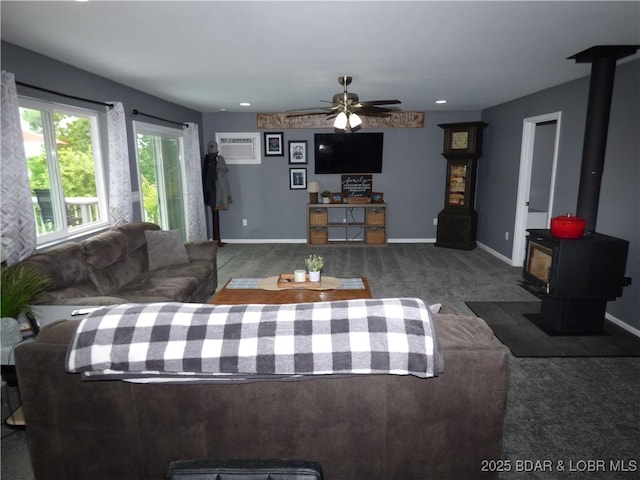 31762 Pecan Dr, Rocky Mount, MO 65072 - living area featuring carpet floors, a wood stove, and ceiling fan