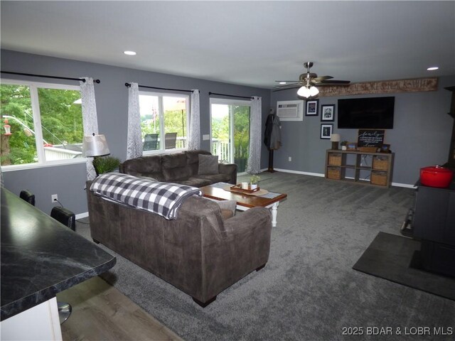 31762 Pecan Dr, Rocky Mount, MO 65072 - living area with ceiling fan, an AC wall unit, carpet floors, and recessed lighting