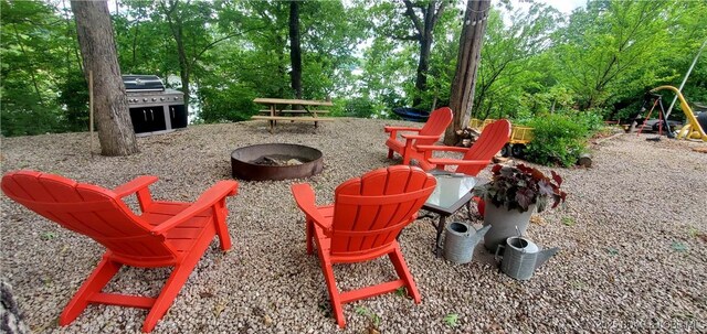31762 Pecan Dr, Rocky Mount, MO 65072 - view of patio featuring a fire pit