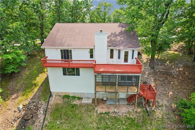 1380 Bluff Dr, Osage Beach, MO 65065 - rear view of property with a sunroom, a chimney, a wooden deck, and stairs
