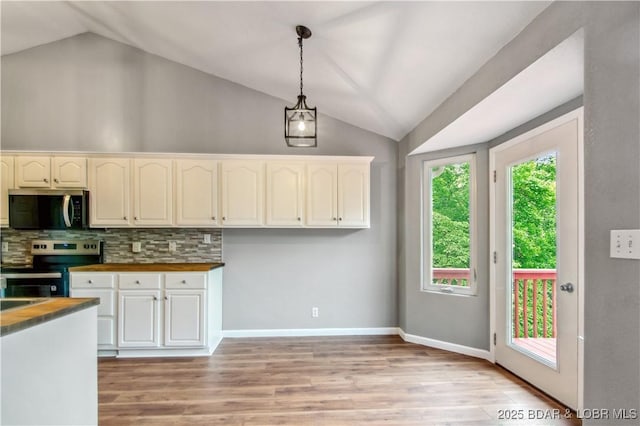 1380 Bluff Dr, Osage Beach, MO 65065 - kitchen featuring stainless steel appliances, lofted ceiling, butcher block counters, light wood-type flooring, and pendant lighting